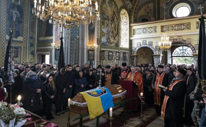 Relatives and friends attend the funeral of Roman Rushchyshyn