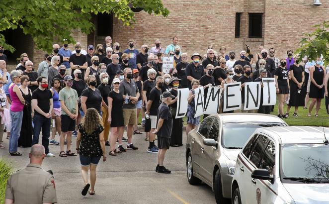 A group of over 50 people dressed in all black