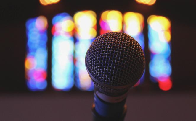 Microphone with stained glass in background.