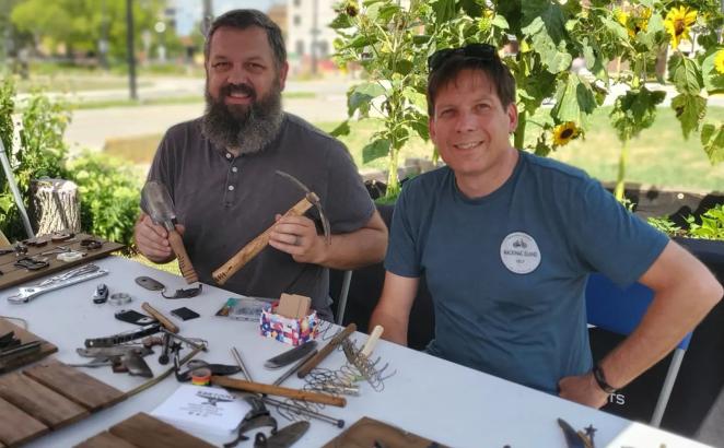 RAWTools blacksmith Mike Martin (left) and Pastor Tim Bossenbroek with gun parts to assemble on garden signs.