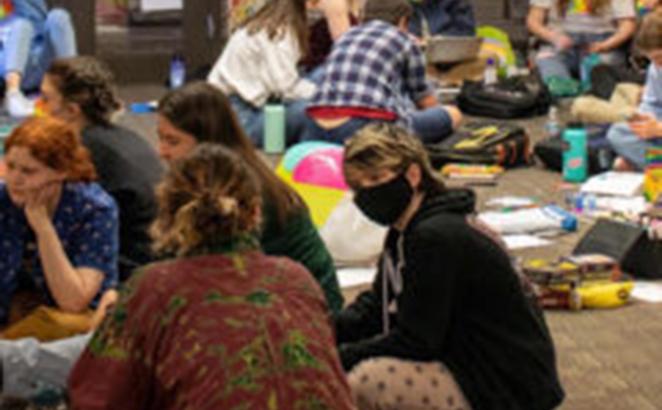 At Seattle Pacific University people participate in a sit-in May 26, 2022, after the board of trustees decided to retain a policy that prohibits the hiring of people in same-sex relationships for full-time positions.