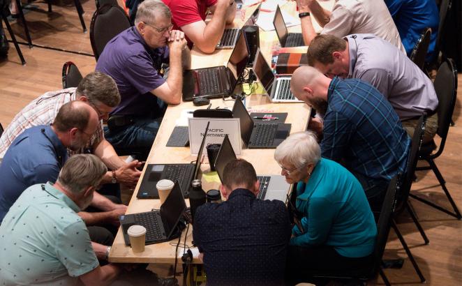 synod delegates praying