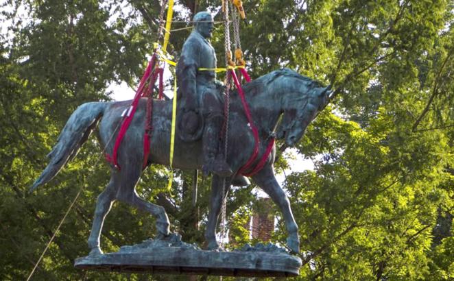 Workers remove the monument of Confederate General Robert E. Lee on Saturday, July 10, 2021, in Charlottesville, Va. The removal of the Lee statue follows years of contention, community anguish and legal fights.