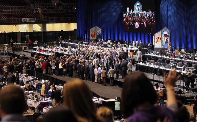 United Methodist bishops and delegates gather to pray before a key vote on church policies about homosexuality on Feb. 26, 2019 