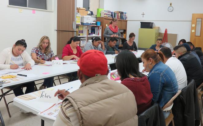 Volunteer Stephanie DenBraber (standing), of First CRC Denver, teaching Cascade of Hope’s beginner level ESL Class.
