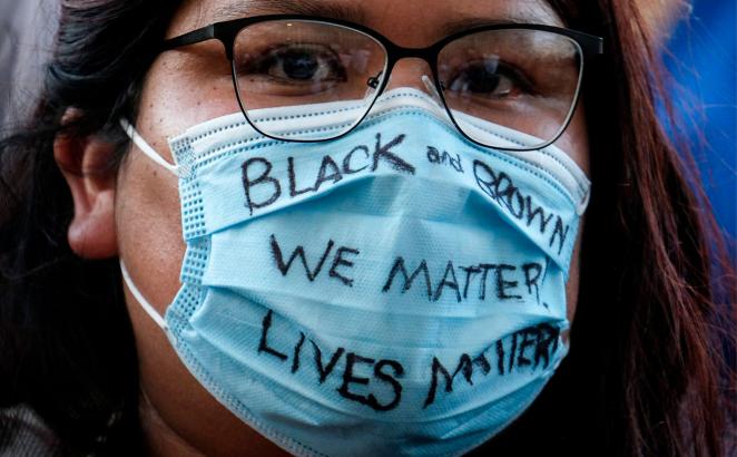 A demonstrator wears a mask with a message during a protest of the death of George Floyd, a black man who was in police custody in Minneapolis, in downtown Los Angeles, on May 27, 2020.
