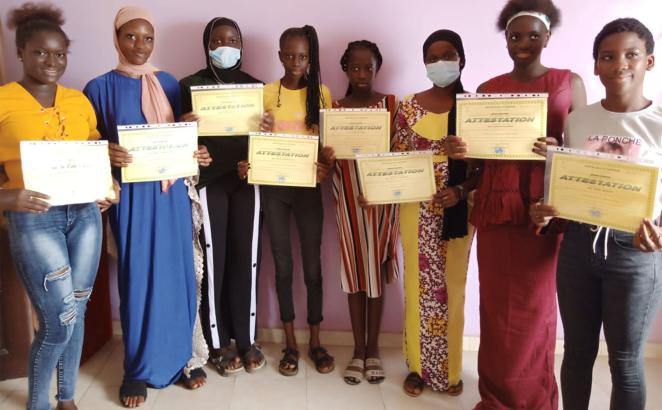 Protecting Adolescent Health and Rights program graduates show off their certificates. 