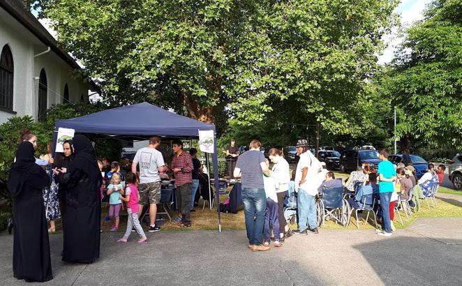 Adjacent to the church and under a big tree, concert goers gathered for music.