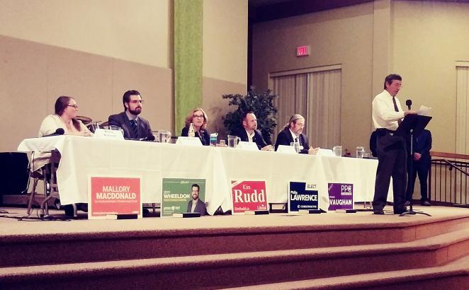 Fellowship CRC member Ron Rupke (at the mic) welcomes residents to the co-sponsored all-candidates meeting.