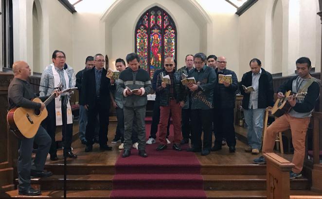 Asylum seeker Harry Pangemanan, right, plays guitar during the Indonesian service at Reformed Church of Highland Park on Jan. 28 in Highland Park, N.J. 