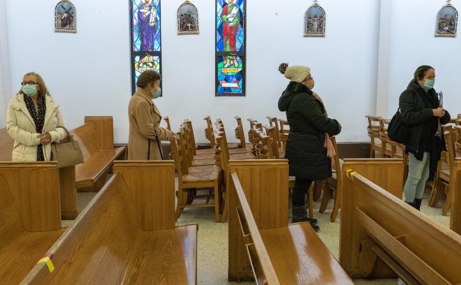 People line up next to the pews at a pop-up COVID-19 vaccination site at St. Luke's Episcopal Church, Tuesday, Jan. 26, 2021, in the Bronx borough of New York. 