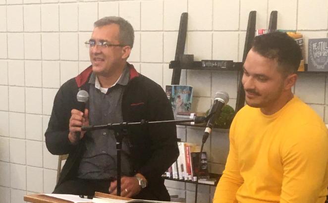 Pastor Yordanys Diaz (left) speaks at Hillside CRC in Kentwood, Mich., about leading the Christian Reformed Church in Cuba. Jonathan Gonzalez translated for the English audience.