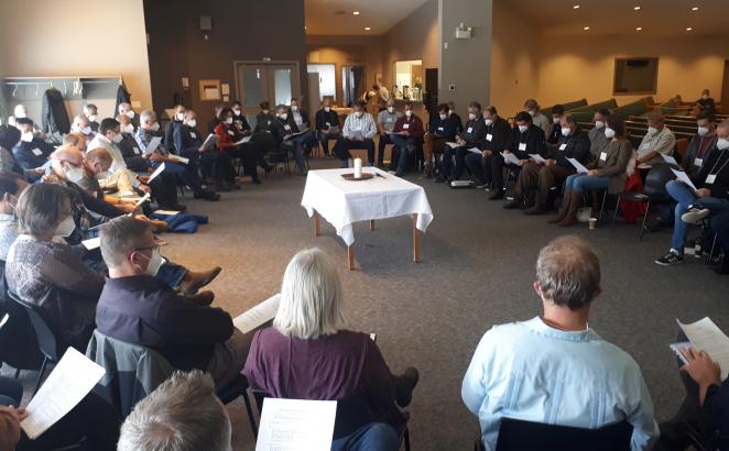 With a Christ candle in the center, delegates to Classis Alberta North conversed in a circle, deliberating over proposed overtures about the human sexuality report coming to Synod 2022.