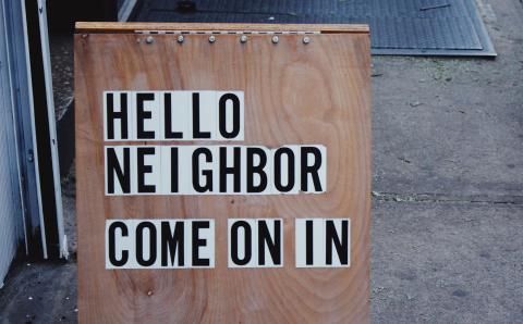 Sandwich sign with Hello Neighbor Come on In