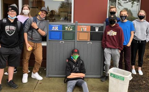 Students stand outside Unity Christian School near the new bins purchased with a grant from Diaconal Ministries.