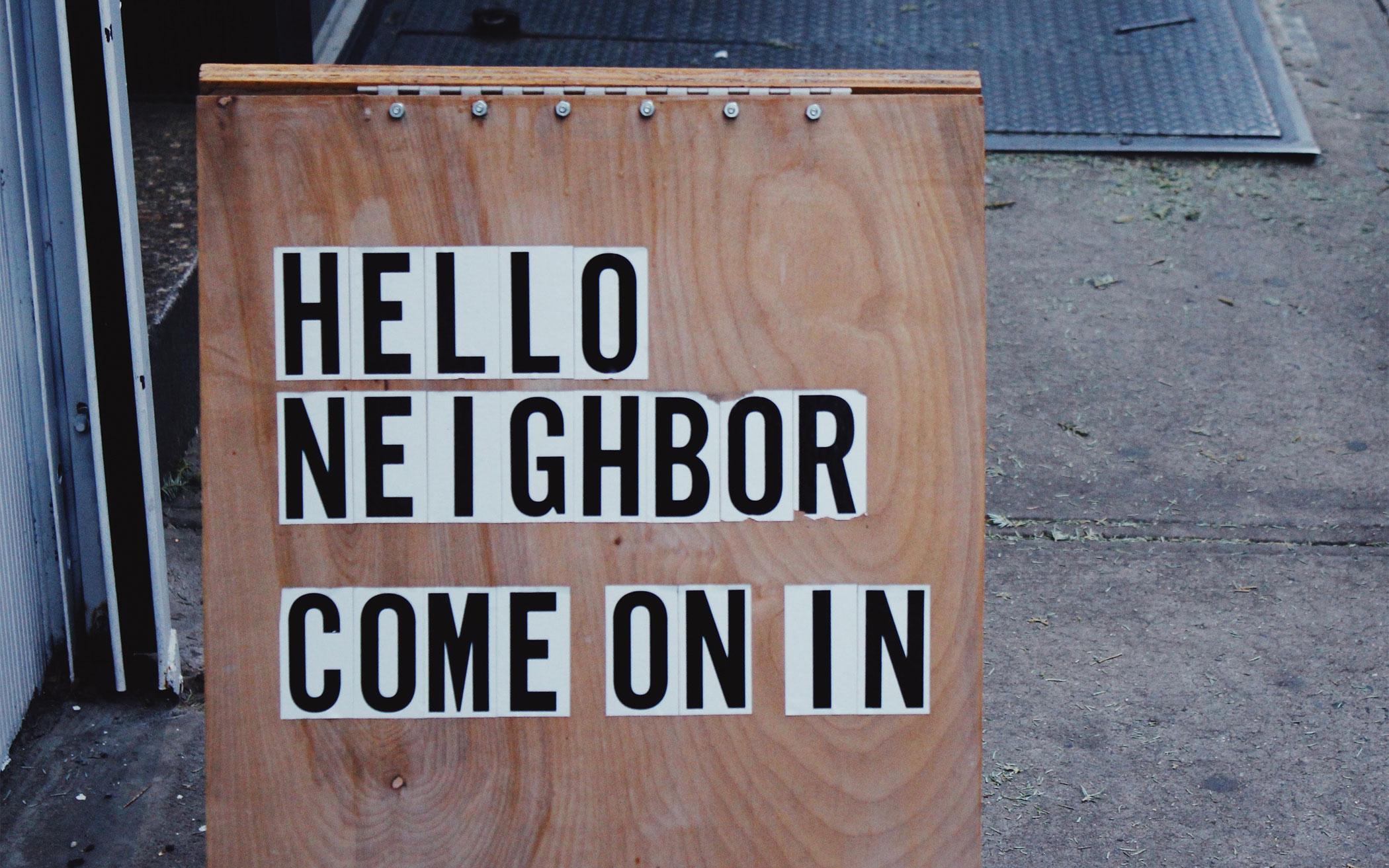 Sandwich sign with Hello Neighbor Come on In