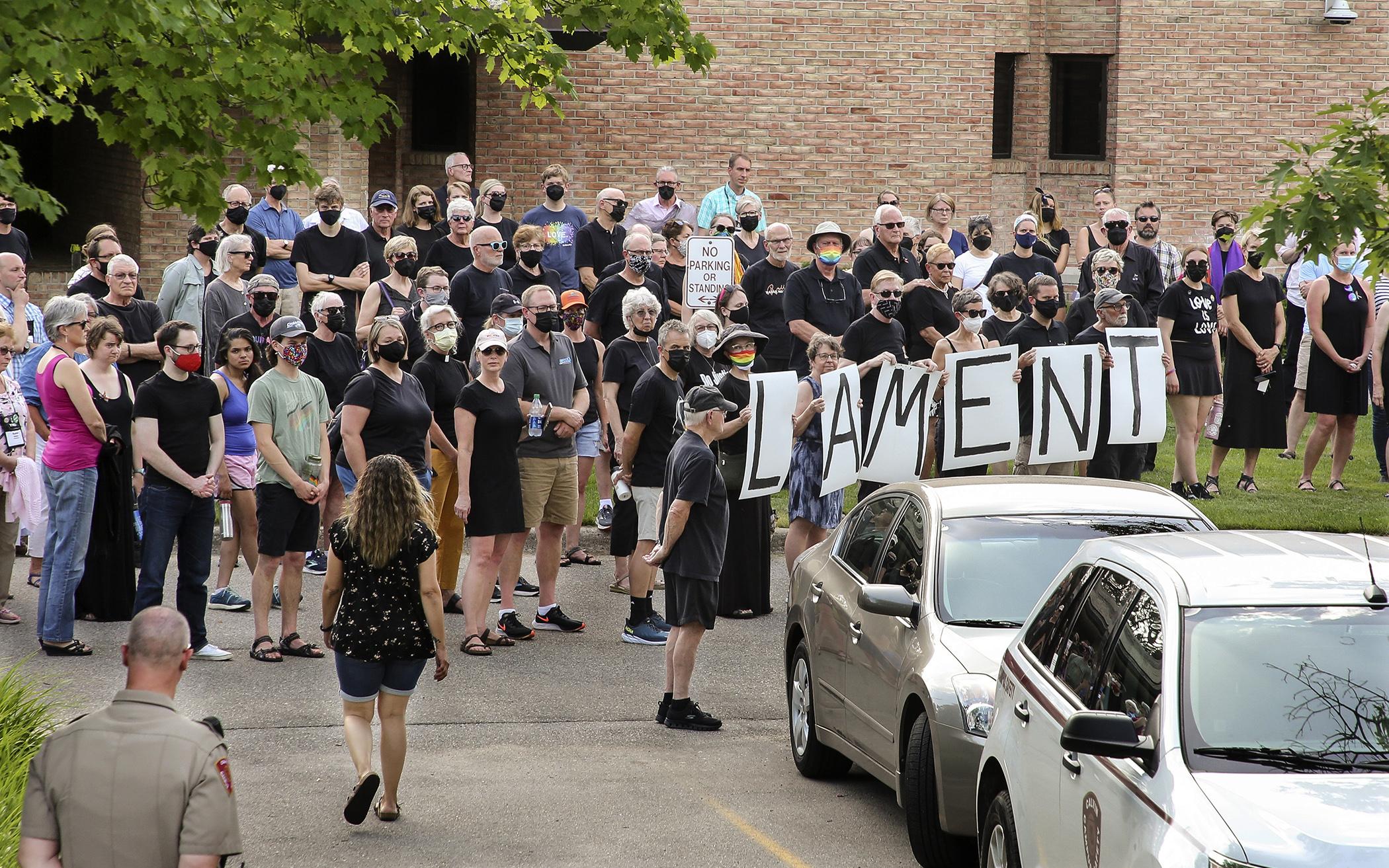 A group of over 50 people dressed in all black