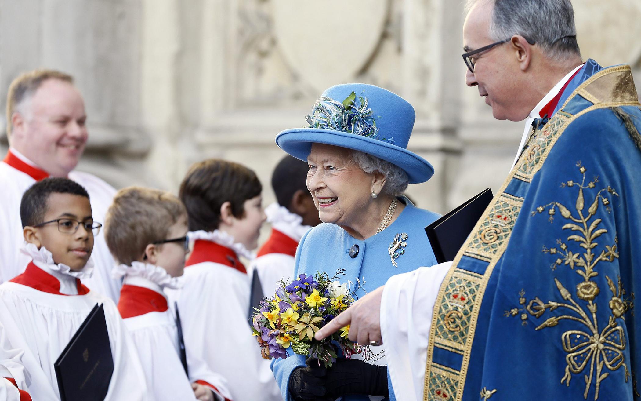 In London, March 14, 2016, Queen Elizabeth II passes the choir as she leaves after attending the Commonwealth Day service at Westminster Abbey.