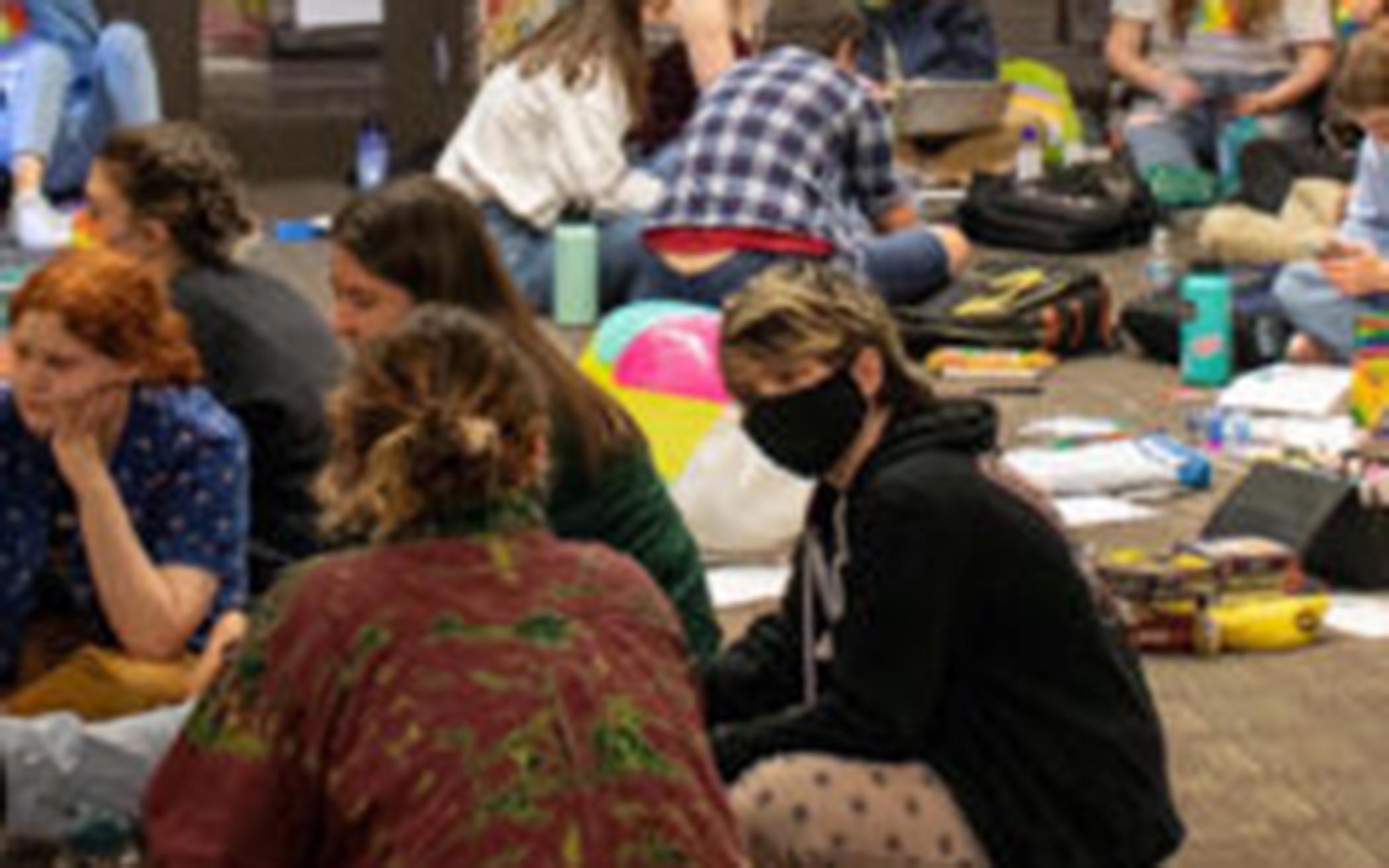 At Seattle Pacific University people participate in a sit-in May 26, 2022, after the board of trustees decided to retain a policy that prohibits the hiring of people in same-sex relationships for full-time positions.