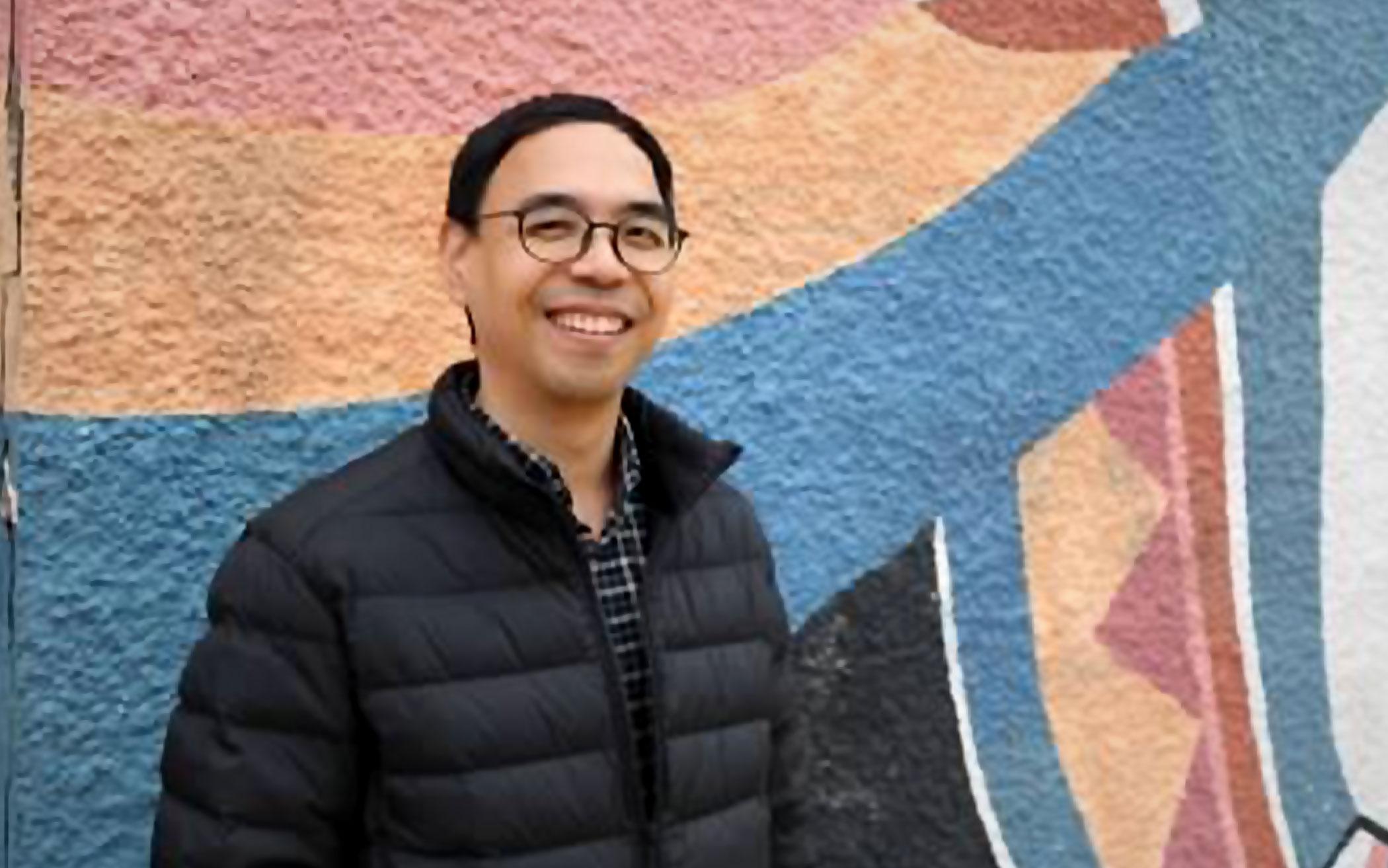 picture of Pablo standing in front of mural