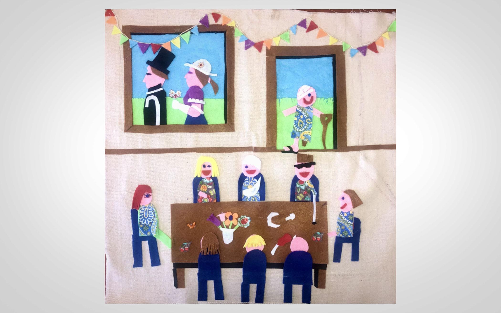 felt artwork showing people around a table