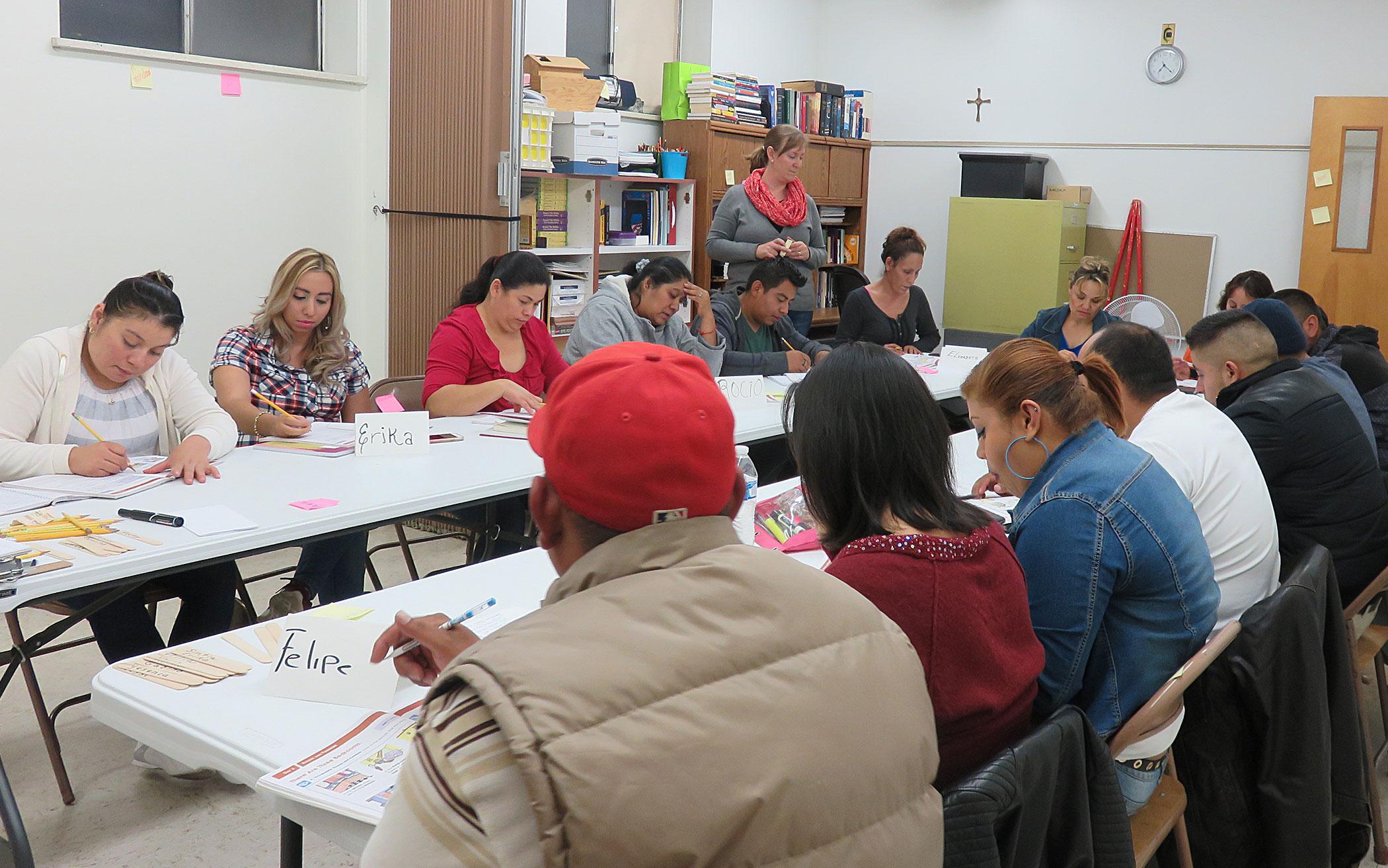 Volunteer Stephanie DenBraber (standing), of First CRC Denver, teaching Cascade of Hope’s beginner level ESL Class.