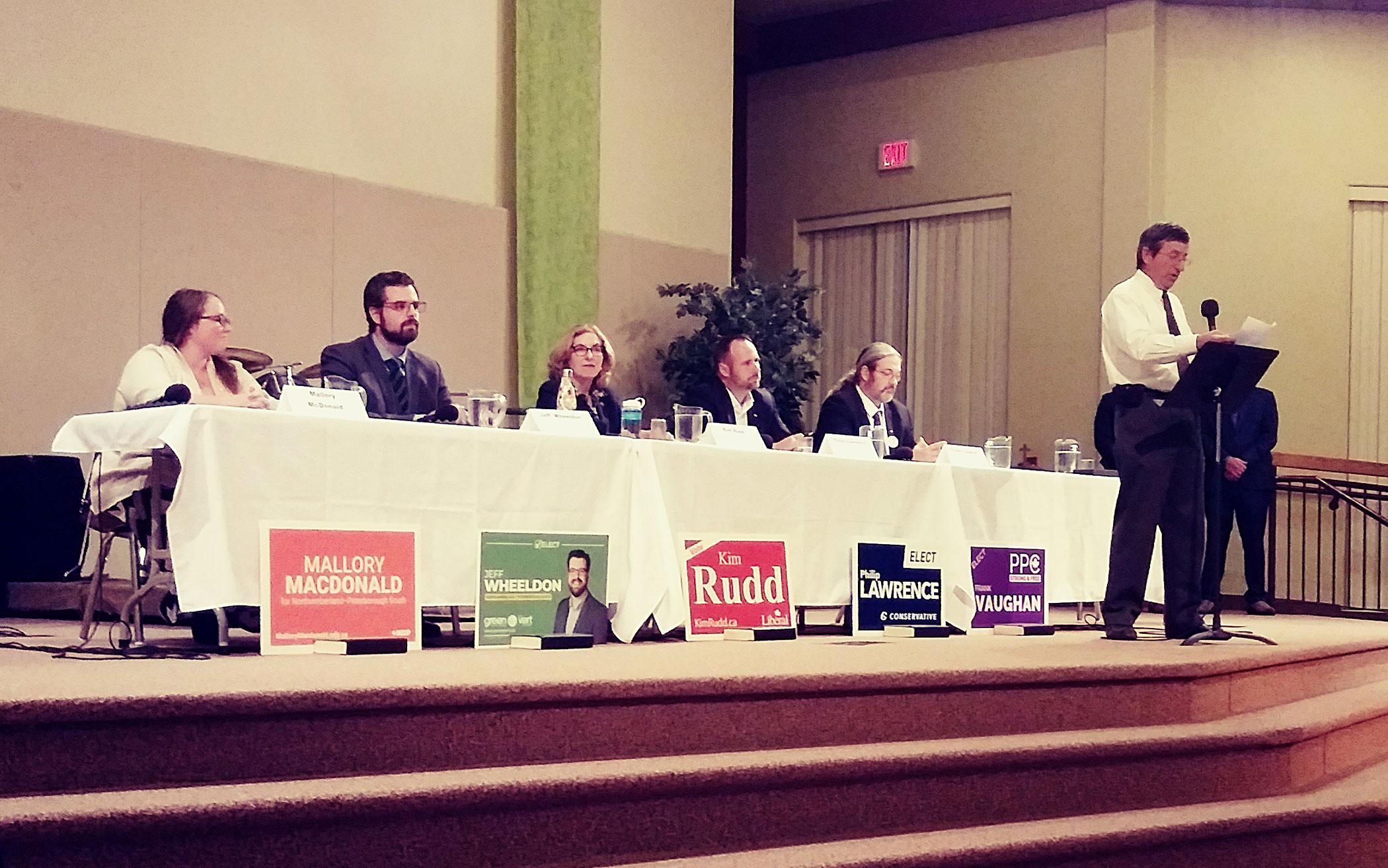 Fellowship CRC member Ron Rupke (at the mic) welcomes residents to the co-sponsored all-candidates meeting.