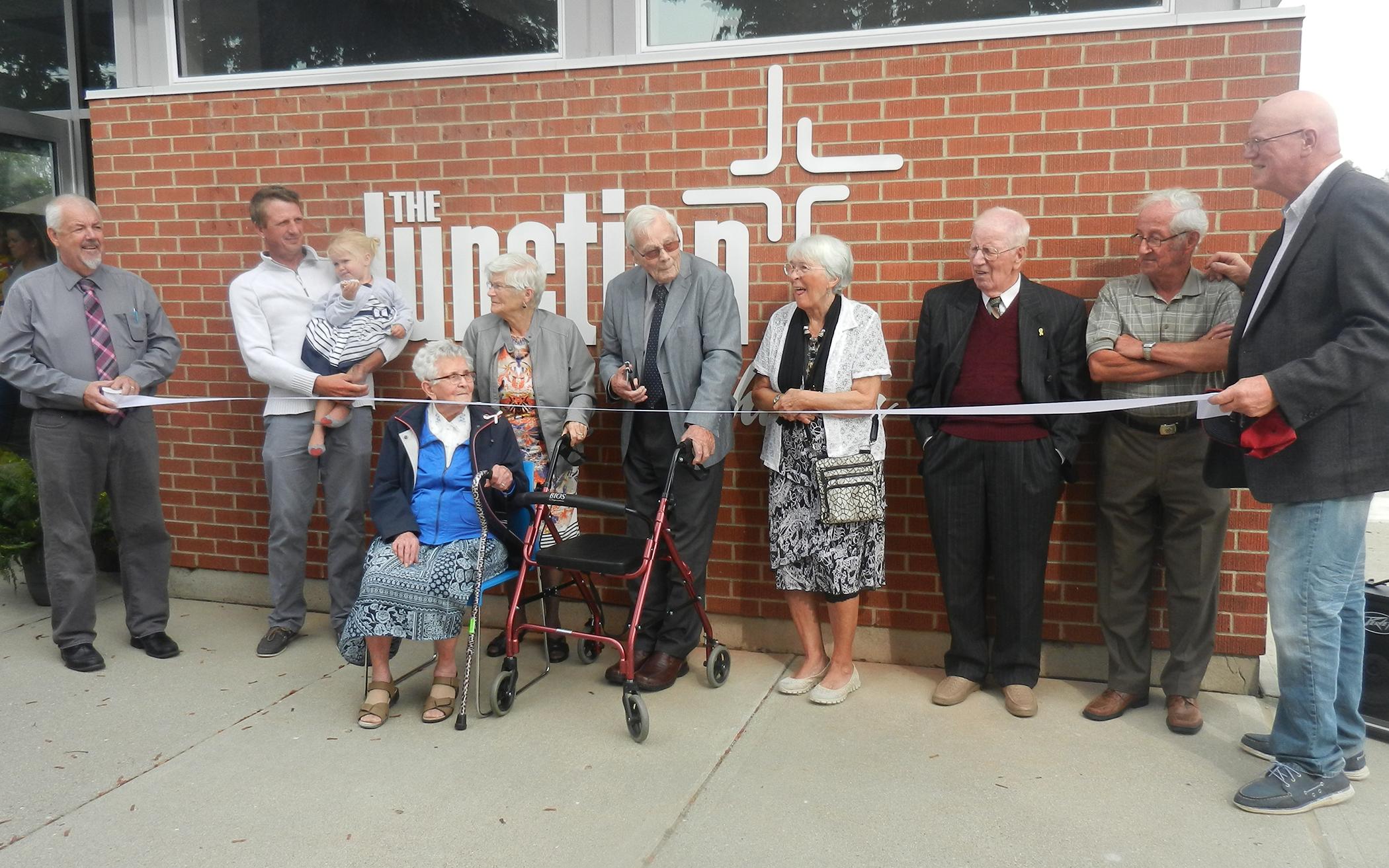 The Junction Church's pastor and chair of council are joined by the youngest, oldest, and some founding members to mark the dedication of their newly renovated church building.