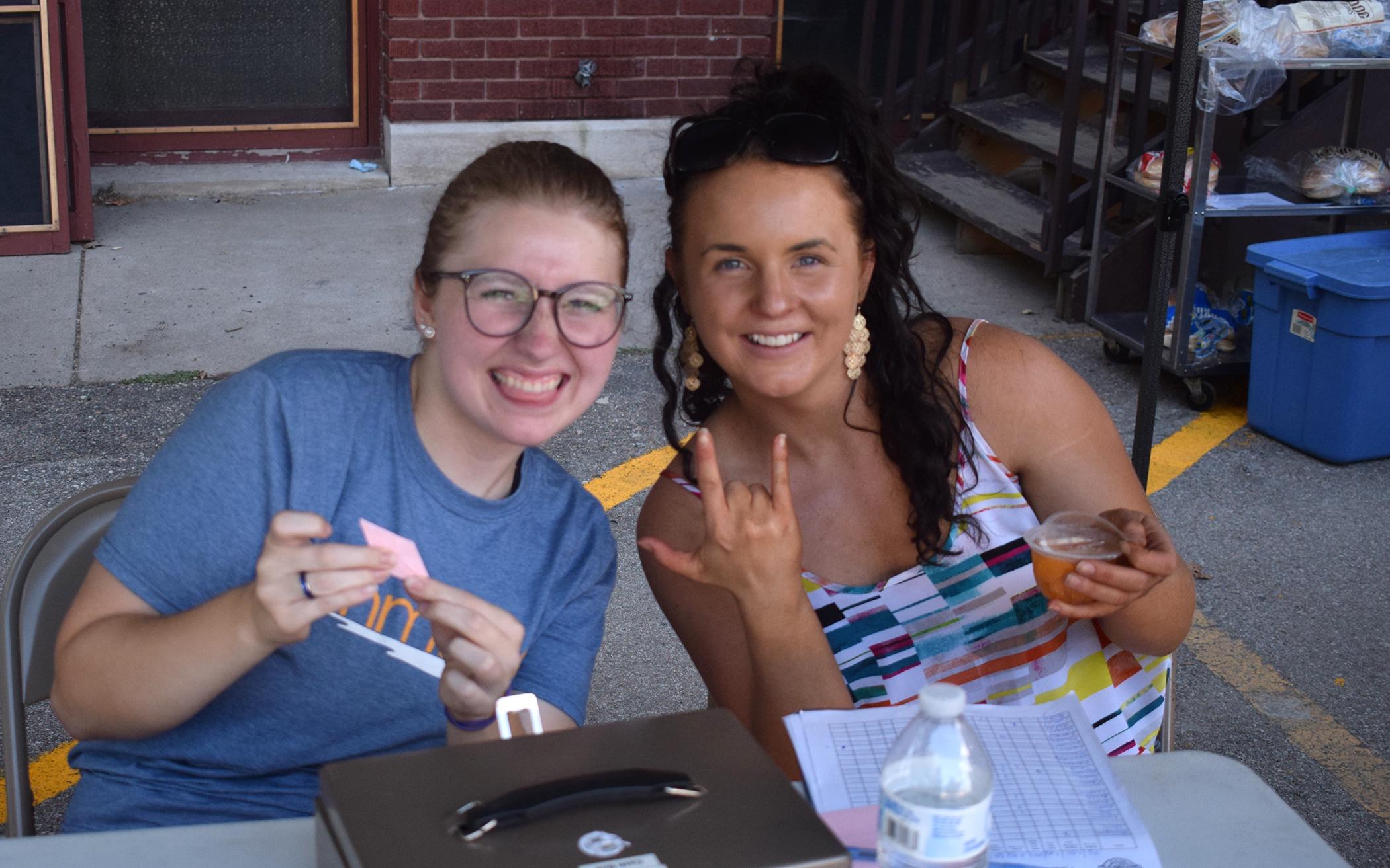 Meg Arbogast (left), here helping a summer intern at F Street Farmers Market, is the Youth Ministry Resident at F Street Church.