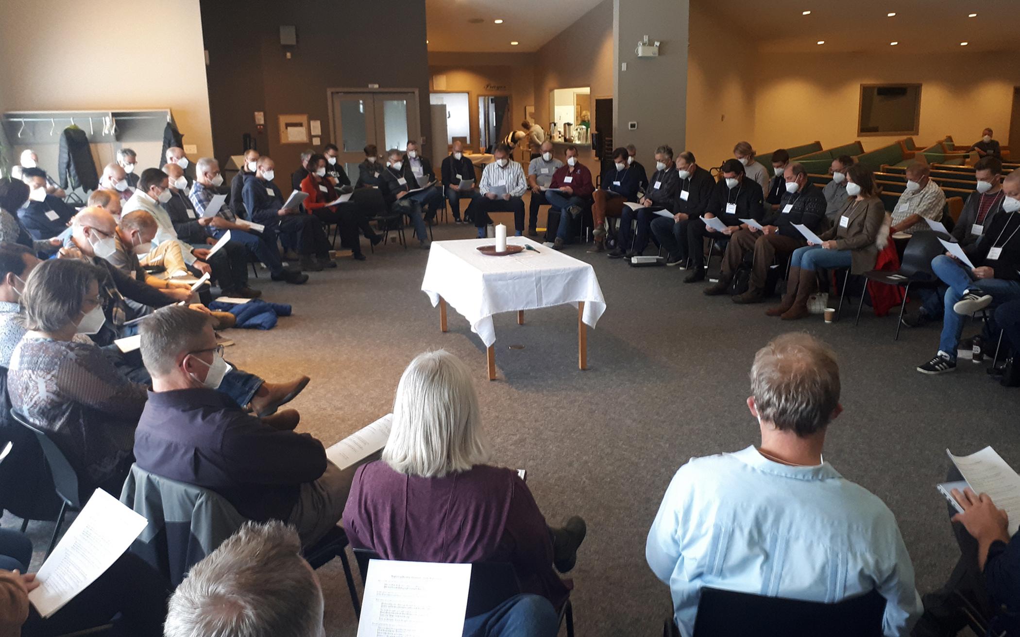 With a Christ candle in the center, delegates to Classis Alberta North conversed in a circle, deliberating over proposed overtures about the human sexuality report coming to Synod 2022.